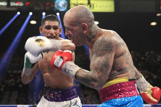 Amir Khan, left, of Britain punches at Luis Collazo of the U.S. during their welterweight fight at the MGM Grand Garden Arena on Saturday, May 3, 2014.