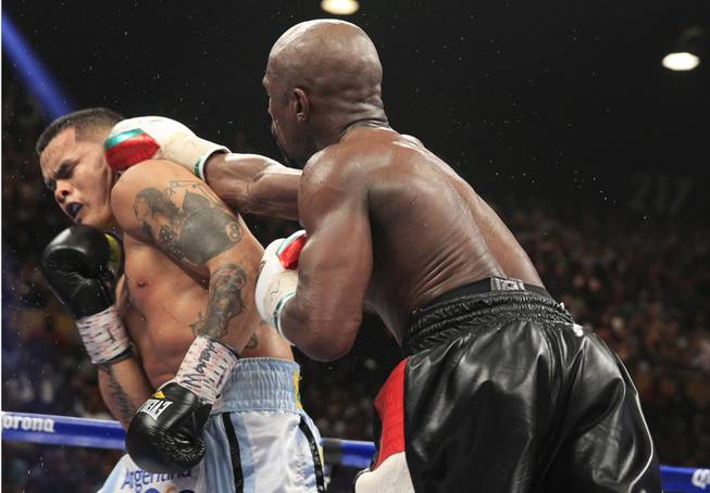 Marcos Maidana, left, of Argentina is punched by Floyd Mayweather Jr. of the U.S. during their WBC/WBA welterweight unification fight at the MGM Grand Garden Arena on Saturday, May 3, 2014.