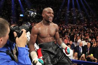 Floyd Mayweather Jr. of the U.S. celebrates his victory over Marcos Maidana of Argentina during their WBC/WBA welterweight unification fight at the MGM Grand Garden Arena on Saturday, May 3, 2014. Mayweather improved his record to 46-0.