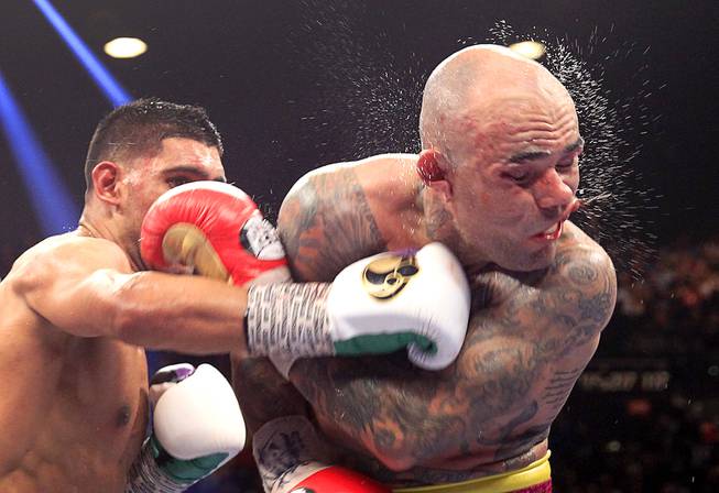 Luis Collazo, right, of the U.S. takes a punch from Amir Khan of Great Britain during their welterweight fight at the MGM Grand Garden Arena on Saturday, May 3, 2014. The Professional Fighters Brain Health Study (PFBHS) by the Cleveland Clinic Lou Ruvo Center for Brain Health is collecting data on combat sports athletes.