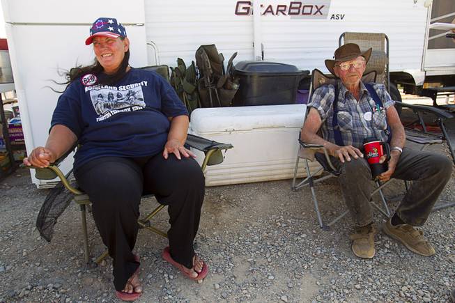Bevalyn Marshall, a cousin of rancher Cliven Bundy, and Jesse Halsell of Northern California, relax at a supporter rally point near Bunkerville, Sunday, May 4, 2014.