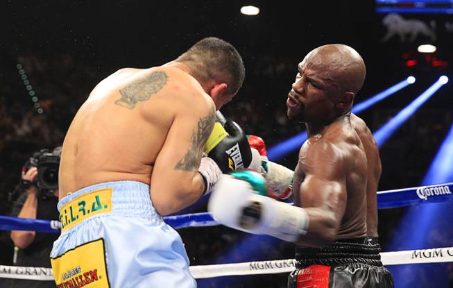 Marcos Maidana, left, of Argentina fights Floyd Mayweather Jr. of the U.S. during their WBC/WBA welterweight unification fight at the MGM Grand Garden Arena on Saturday, May 3, 2014.