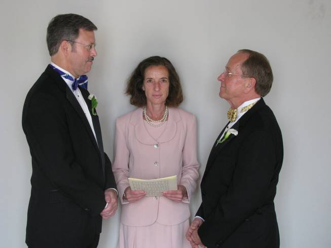 In this photo released by the Episcopal Dioceses of New Hampshire, Mark Andrew, left, and Bishop V. Gene Robinson are shown during their private civil union ceremony performed by Ronna Wise in Concord, N.H., on June 7, 2008. Robinson, the first openly gay Episcopal bishop, announced Saturday, May 3, 2014, he is getting divorced from Andrew.