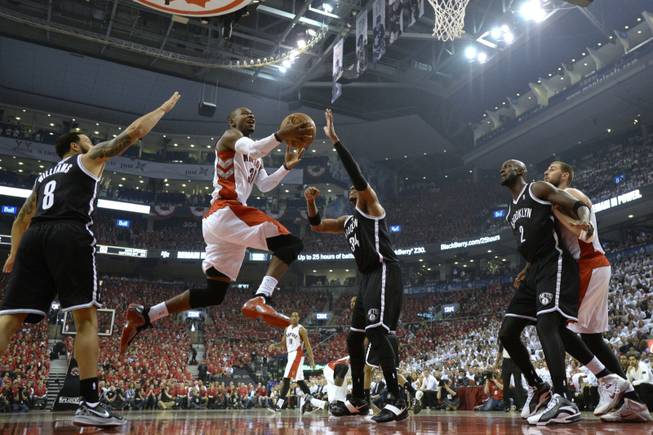 The Toronto Raptors' Terrence Ross (31) drives to the net against the Brooklyn Nets' Deron Williams (8) and Paul Pierce (34) as the Nets' Kevin Garnett (2) boxes out the Raptors' Jonas Valanciunas during the first half of Game 7 of the opening-round NBA basketball playoff series in Toronto on Sunday, May 4, 2014.