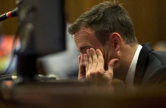 Oscar Pistorius reacts as he listens to evidence by a pathologist in court in Pretoria, South Africa, on April 7, 2014. The murder trial of Pistorius is expected to enter a crucial phase of testimony Monday as the defense attempts to overcome a faltering start and show how the disabled Olympic athlete fatally shot girlfriend Reeva Steenkamp by mistake because he was overwhelmed by a long-held fear of violent crime.
