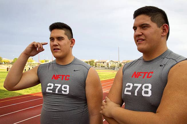 Las Vegas High offensive linemen Mark Gil Gacutan, left, and Mark Anthony Gacutan respond to questions during an interview at Las Vegas High School on Monday, May 5, 2014. Doctors initially thought they had gigantism, abnormally large growth due to an excess of growth hormone, because they grew so fast, they said.