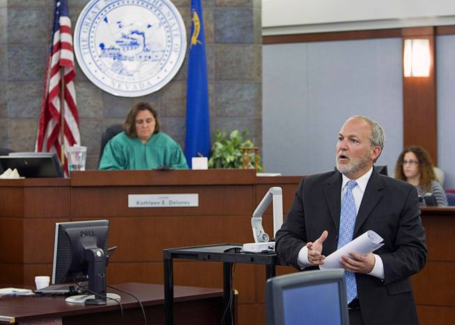 Prosecutor Marc DiGiacomo, right, speaks to potential jurors as jury selection begins in the trial for Jason "Blu" Griffith, the man accused of killing Luxor "Fantasy" dancer Debora Flores Narvaez, at the Regional Justice Center Monday, May 5, 2014. District Court Judge Kathleen Delaney is in the background.