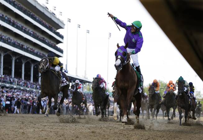 Victor Espinoza rides California Chrome to victory during the 140th running of the Kentucky Derby horse race at Churchill Downs Saturday, May 3, 2014, in Louisville, Ky.  (AP Photo/David J. Phillip)