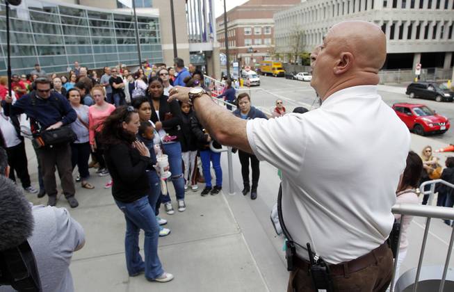 Tony Feola, right, with the Dunkin' Donuts Center security department, informs the crowd that the 3:00 p.m. and 7:00 p.m. shows of the Ringling Bros. and Barnum & Bailey Circus are canceled, Sunday, May 4, 2014, in Providence, R.I. 