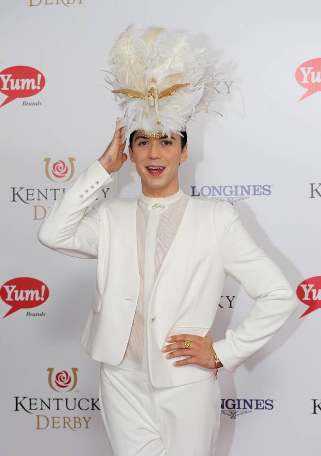 Johnny Weir adjusts his hat on the red carpet at the 140th Kentucky Derby Saturday, May 3, 2014 in Louisville Ky. 