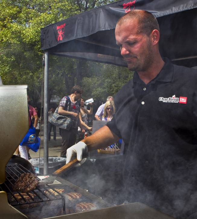 Michael Orth of Jacksonville, Fl., grills up another batch of burgers at the Char-Broil display during the National Hardware Show 2014 outside the Las Vegas Convention Center on Wednesday, May 7, 2014.   L.E. Baskow
