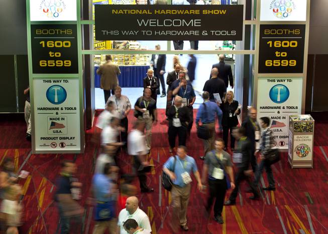 Attendees and staff stream about an entrance to the National Hardware Show 2014 in the Las Vegas Convention Center on Wednesday, May 7, 2014.   L.E. Baskow