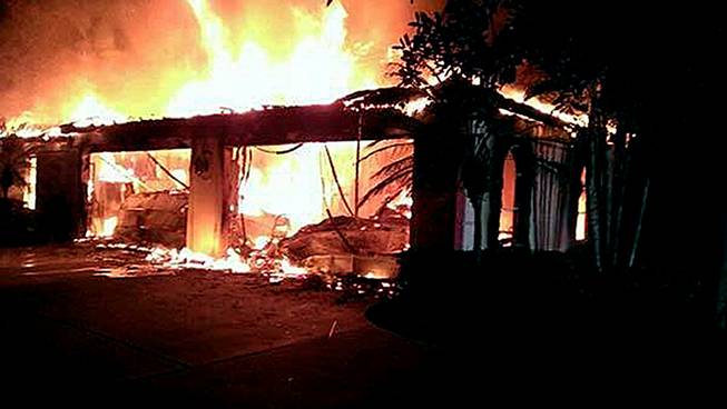 In this photo provided by the Hillsborough County Sheriff's Office, flames destroy a mansion owned by former tennis star James Blake Wednesday, May 7, 2014, in a gated community in Tampa, Fla. 