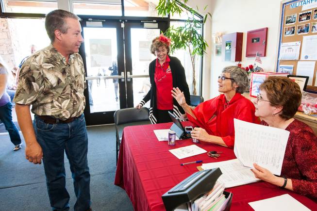 GriefShare facilitator Carol Von Eschen encourages John Robinson to donate blood while working the booth with Kitty Metzger, center, and Brenda Wendling, right, during the blood drive at New Song Church in Henderson Sunday, April 6, 2014.