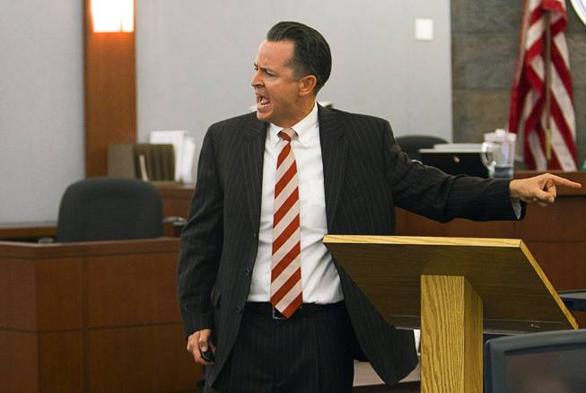 Defense attorney Jeff Banks points to his client during opening statements during the trial for Jason Omar Griffith at the Regional Justice Center Thursday, May 8, 2014. Griffith is accused of murdering Luxor "Fantasy" dancer Deborah Flores Narvaez in December 2010.