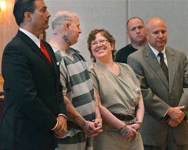 Jeremy Lee Moody and his wife Christine smile at each other before they were both sentenced to life in prison on Tuesday, May 6, 2014, in Union, S.C. Authorities say Jeremy and Christine Moody killed 59-year-old Charles Parker and his 51-year-old wife, Gretchen Parker, last July, stabbing and shooting them. Investigators say the Moodys decided to kill Parker because he had taken advantage of a disabled woman.