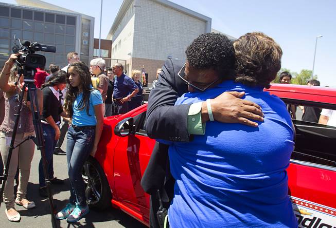 Math teacher Perryn Hale hugs school office manager Cindy Teasdale after Hale was surprised with a new car on the final day of Teacher Appreciation Week at Roy Martin Middle School Friday, May 9, 2014. Appreciation Financial, an insurance and financial services company, and Findlay Chevrolet teamed up to give a fully-loaded 2014 Chevrolet Sonic RS Turbo to Hale.