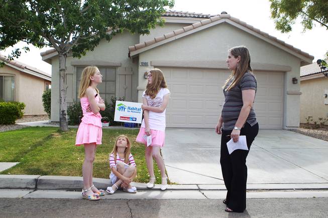Katelyn, Emily, Danielle and their mother Denzi Watts wait for the start of the presentation of their home which was donated by Bank of America and rehabilitated with the help of Habitat for Humanity Friday, May 9, 2014.