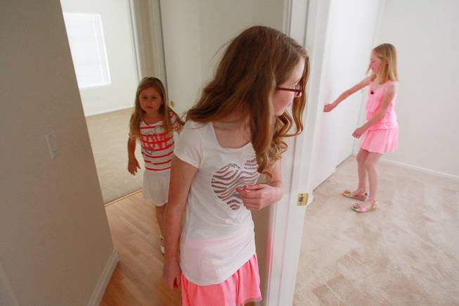 Emily, Danielle an Katelyn Watts inspect bedrooms after the presentation of their home which was donated by Bank of America and rehabilitated with the help of Habitat for Humanity Friday, May 9, 2014.