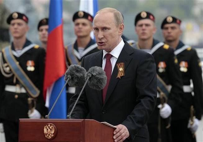 Russian President Vladimir Putin speaks at a navy parade marking the Victory Day in Sevastopol, Crimea, Friday, May 9, 2014.Putin extolled the return of Crimea to Russia before tens of thousands Friday during his first trip to Black Sea peninsula since its annexation. The triumphant visit was quickly condemned by Ukraine and NATO.