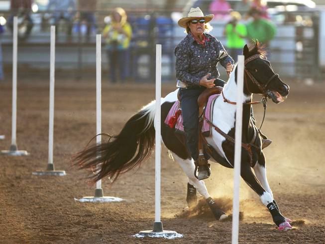 Karen Beavers competes in pole bending during the Bighorn Rodeo Saturday, May 10, 2014. The Bighorn Rodeo is an annual event put on by the Nevada Gay Rodeo Association.