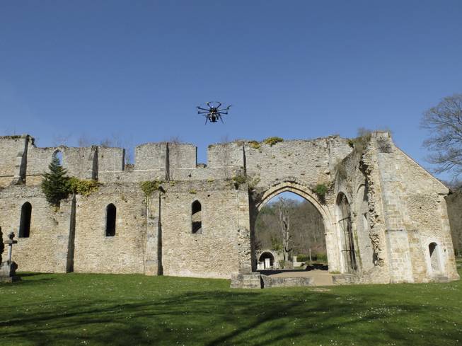 A drone flies at the Abbaye Des-Vaux-de-Cernay southwest of Paris, Thursday March 20, 2014. French drone operator Jean-Luc  Fornier operated the remote controlled drone used to used to transmit live video of snowboard and ski jump competitions at the Sochi Olympic Games.