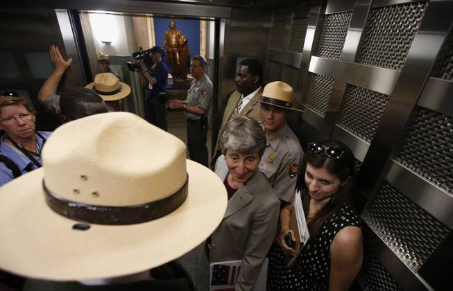 Interior Secretary Sally Jewell, center, rides an elevator to the 500-foot level at the Washington Monument in Washington, Monday, May 12, 2014, after a ceremony to celebrate its re-opening. The monument, which sustained damage from an earthquake in August 2011, reopened to the public today. 