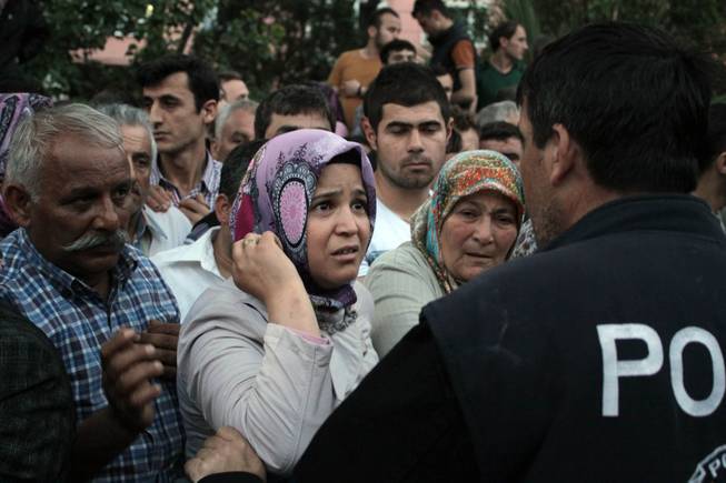 Relatives try to get information outside a local hospital after an explosion and fire at a coal mine in Soma, in western Turkey, Tuesday, May 13, 2014.