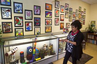 Dee Dee Woodberry, activities and art director, stands by a display of artwork made by seniors at the Nevada Senior Services Adult Day Care Center of Las Vegas, 901 N. Jones Blvd., Wednesday, May 14, 2014. The artwork at the center is mostly made with repurposed materials.