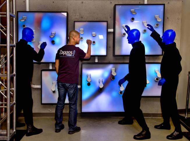 Zappos CEO Tony Hsieh joins the Blue Man Group as they unveil a collaborative, interactive art installation entitled ShoeZaphone during the10th Annual Zappos Bald and Blue charity event on Wednesday, May 15, 2014.