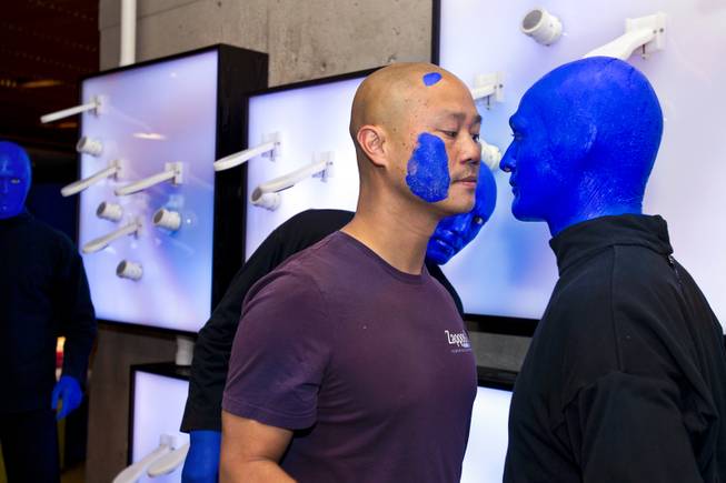Zappos CEO Tony Hsieh jokes with a Blue Man as they unveil a collaborative, interactive art installation entitled ShoeZaphone during the 10th Annual Zappos Bald and Blue charity event on Wednesday, May 15, 2014.