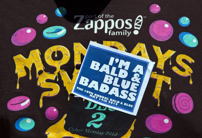 A sticker on the tee shirt of Zappos' audio-visual team member Mikey Maneeraj during the 10th Annual Zappos Bald and Blue charity event on Wednesday, May 15, 2014.