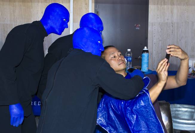 The Blue Man Group poses with Zappos CEO Tony Hsieh for a "selfie" during the 10th Annual Zappos Bald and Blue charity event on Wednesday, May 15, 2014.