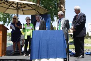 Benefactors Dorothy and Lacy Harber are joined by Associate Executive Director Linda Smith, left, Executive Director Ed Guthrie and foundation president Bob Brown, far right, as they read a statement during an event for Opportunity Village Thursday, May 1, 2014.