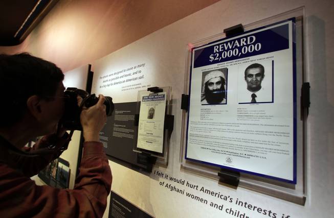 The wanted posters of Osama Bin Laden, left, and Khaled Shaikh Mohammad are displayed at the National Sept. 11 Memorial Museum, Wednesday, May 14, 2014, in New York. The museum is a monument to how the Sept. 11 terror attacks shaped history, from its heart-wrenching artifacts to the underground space that houses them amid the remnants of the fallen twin towers' foundations. It also reflects the complexity of crafting a public understanding of the terrorist attacks and reconceiving ground zero.  (AP Photo)