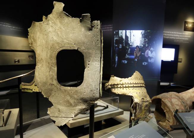 Fragments of the fuselage of Flight 11, that hit the World Trader Center, are displayed at the National Sept. 11 Memorial Museum, Wednesday, May 14, 2014, in New York. The museum is a monument to how the Sept. 11 terror attacks shaped history, from its heart-wrenching artifacts to the underground space that houses them amid the remnants of the fallen twin towers' foundations. It also reflects the complexity of crafting a public understanding of the terrorist attacks and reconceiving ground zero.  (AP Photo)