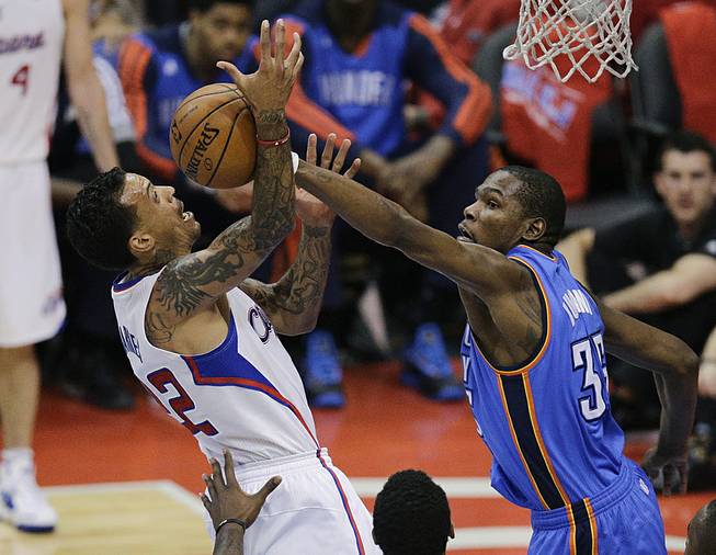 Los Angeles Clippers' Matt Barnes, left, gets his shot blocked by Oklahoma City Thunder's Kevin Durant during the second half in Game 6 of the NBA Western Conference semi-finals on Thursday, May 15, 2014, in Los Angeles. 