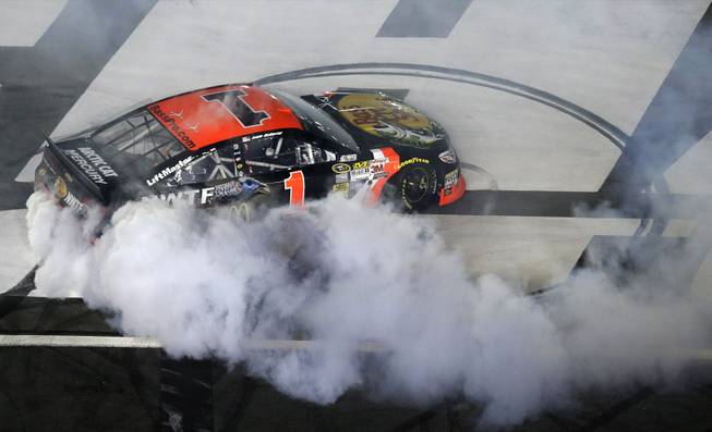 Jamie McMurray does a burnout after his victory in the NASCAR Sprint All-Star race at Charlotte Motor Speedway in Concord, N.C., on Saturday, May 17, 2014.