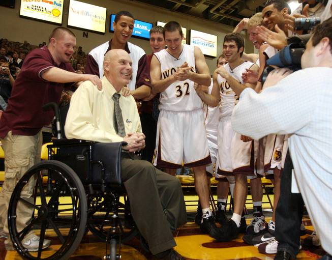 This Jan. 10, 2009, file photo shows Northern State University men's basketball coach Don Meyer, second from left, smiling as he celebrates his 903rd career victory in Aberdeen, S.D. Meyer, one of the winningest coaches in college basketball who came back from a near-fatal car accident and liver cancer before closing out his career, died Sunday, May 18, 2014, in South Dakota. He was 69.