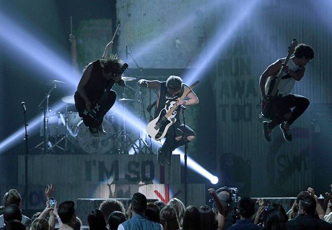 Members of 5 Seconds of Summer perform during the 2014 Billboard Music Awards at the MGM Grand Garden Arena Sunday, May 18, 2014.