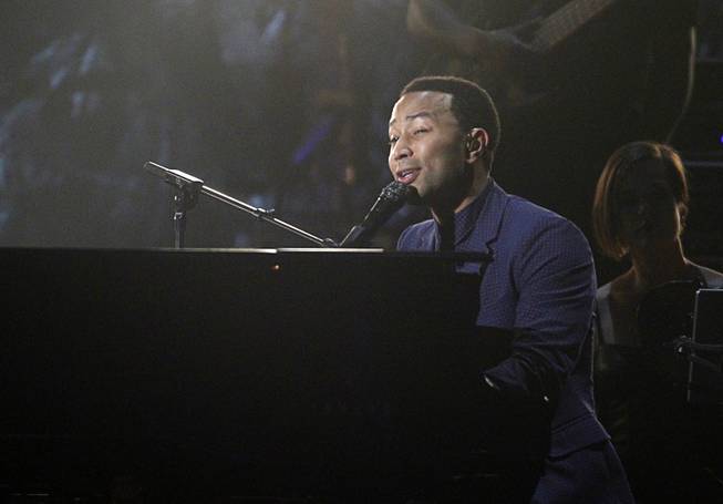 John Legend performs on piano during the 2014 Billboard Music Awards at the MGM Grand Garden Arena Sunday, May 18, 2014.
