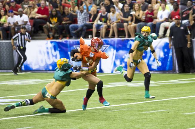 Danika Brace, of the Las Vegas SIN, makes a running play against Green Bay Chill at Thomas & Mack Center, Thursday May 15, 2014. The SIN beat Green Bay 34 to 24, their first win of the Legends Football League season.
