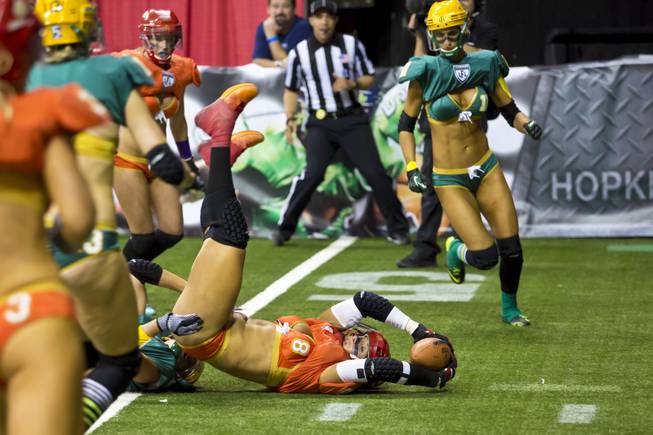 Danika Brace, of the Las Vegas SIN, completes a pass before being tackled by Green Bay Chill at Thomas & Mack Center, Thursday May 15, 2014. The SIN beat Green Bay 34 to 24, their first win of the Legends Football League season.
