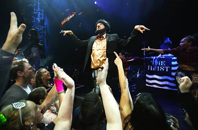 In this photo taken Friday, May 16, 2014, Macklemore performs "Thrift Shop" during Vivid: Spectacle Opening Night Party at the EMP Museum in Seattle. 
