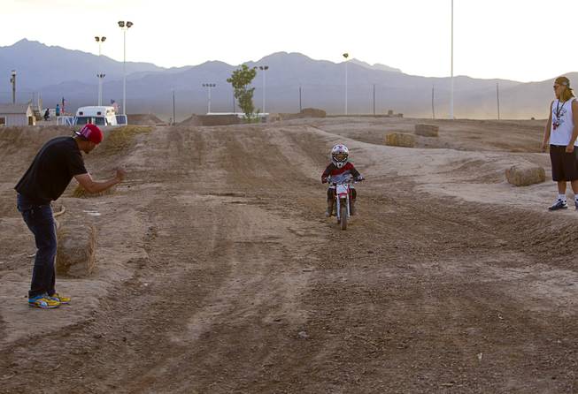 Thomas Ramirez, left, of Las Vegas, gives encouragement to his son on the pee-wee course at Sandy Valley MX in Sandy Valley Thursday, May 15, 2014. Ramirez said both his sons Thomas Jr, 7, and Ryder, 4, ride motocross.