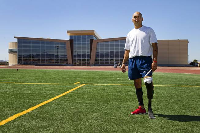 Mstr. Sgt. Christopher Aguilera poses at the outdoor track at Nellis Air Force Base Wednesday, May 21, 2014. Aguilera was selected as one of 40 Air Force members to participate in the 2014 London Invictus Games for wounded veterans. Aguilera was injured when his helicopter was shot down in Afghanistan in 2010.
