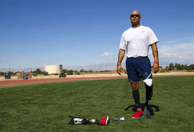 Mstr. Sgt. Christopher Aguilera poses before a run at the outdoor track at Nellis Air Force Base Wednesday, May 21, 2014. Aguilera was selected as one of 40 Air Force members to participate in the 2014 London Invictus Games for wounded veterans. Aguilera was injured when his helicopter was shot down in Afghanistan in 2010.