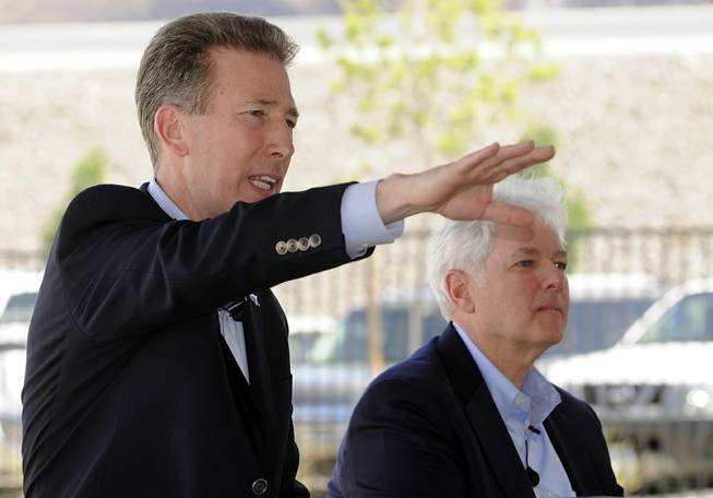 Cox Communications President Pat Esser, left, is flanked by Cox Market Vice President Mike Bolognini as he gestures towards a gathered crowd while discussing his company's plan to introduce gigabit speed internet in the Las Vegas Valley at the future site of the Dream Apartment Community in Henderson on Thursday, May 22, 2014. 
