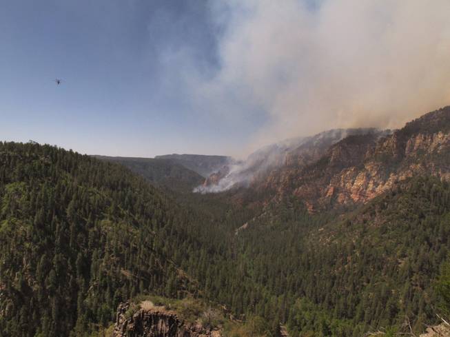 A wildfire burning in Oak Creek Canyon in northern Arizona has forced people out of the popular recreation area on Wednesday, May 21, 2014. 