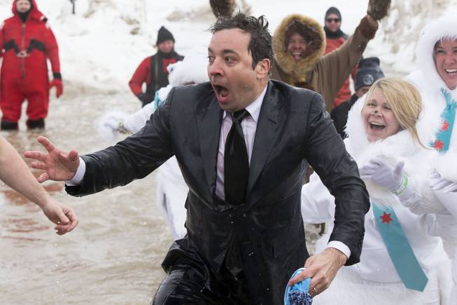 In this March 2, 2014, file photo, Jimmy Fallon, host of "The Tonight Show," exits the icy waters of Lake Michigan during the "Polar Plunge" in Chicago. Fallon was joined Chicago Mayor Rahm Emanuel in the event. Emanuel will now appear on "The Tonight Show" with Jimmy Fallon on June 3, making good on his promise after Fallon came to participate in the event.